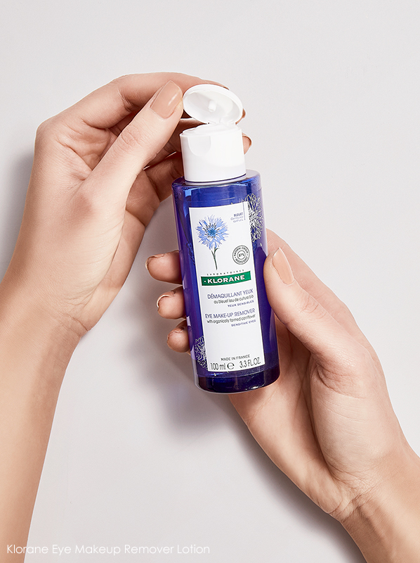 Image of model holding of Klorane Eye Makeup Remover Lotion - Organic