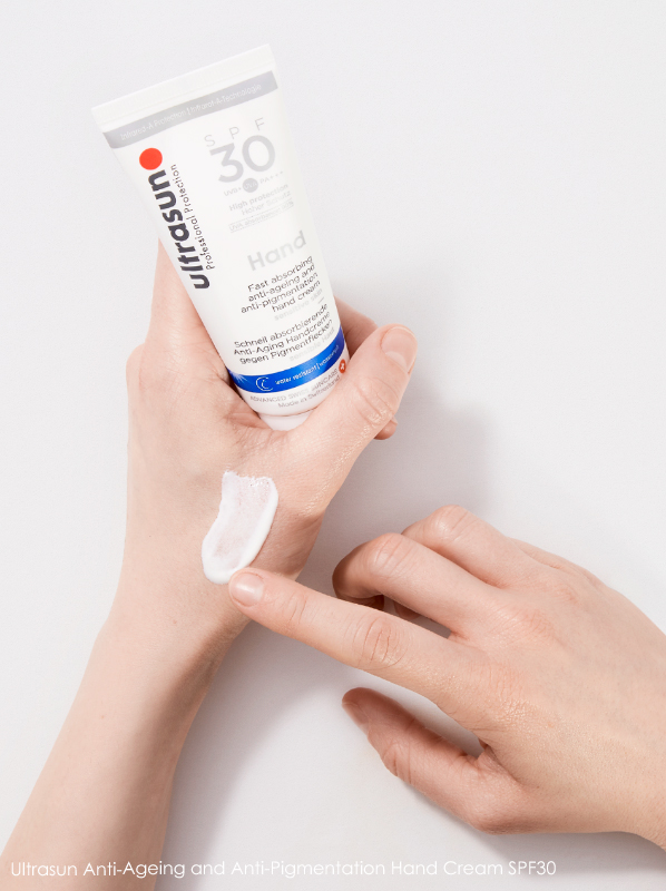 Image of Ultrasun Anti-Ageing and Anti-Pigmentation Hand Cream SPF30 being applied to hands