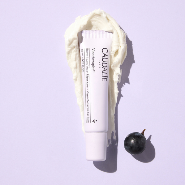Image of Caudalie Vinotherapist Vegan Repairing Lip Balm product and a texture swatch next to a grape